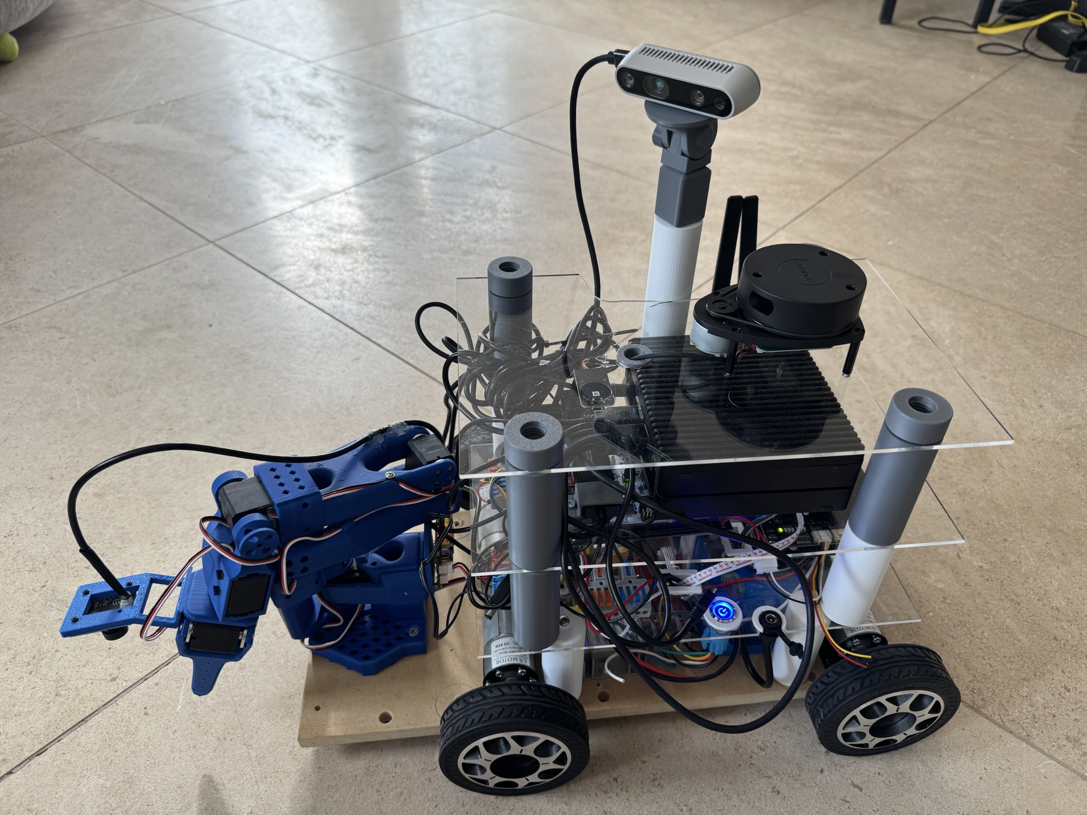 Lumi prototype robot with mobile base, sensors, and front-mounted arm on an indoor floor